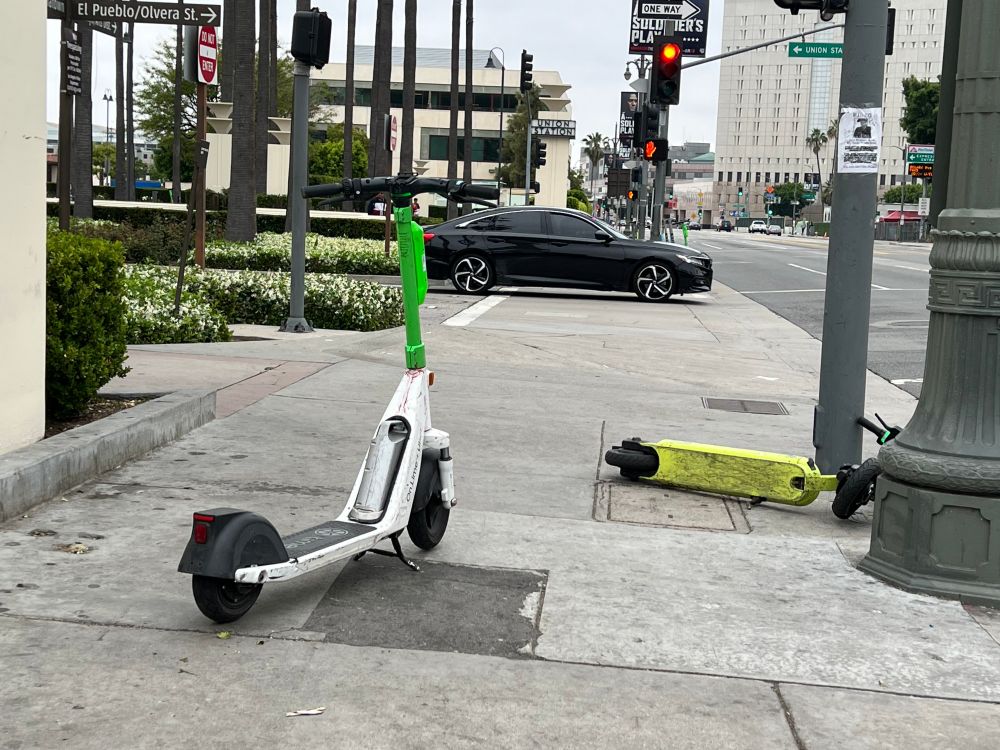 electric scooters on "sharing" network blocking a sidewalk
