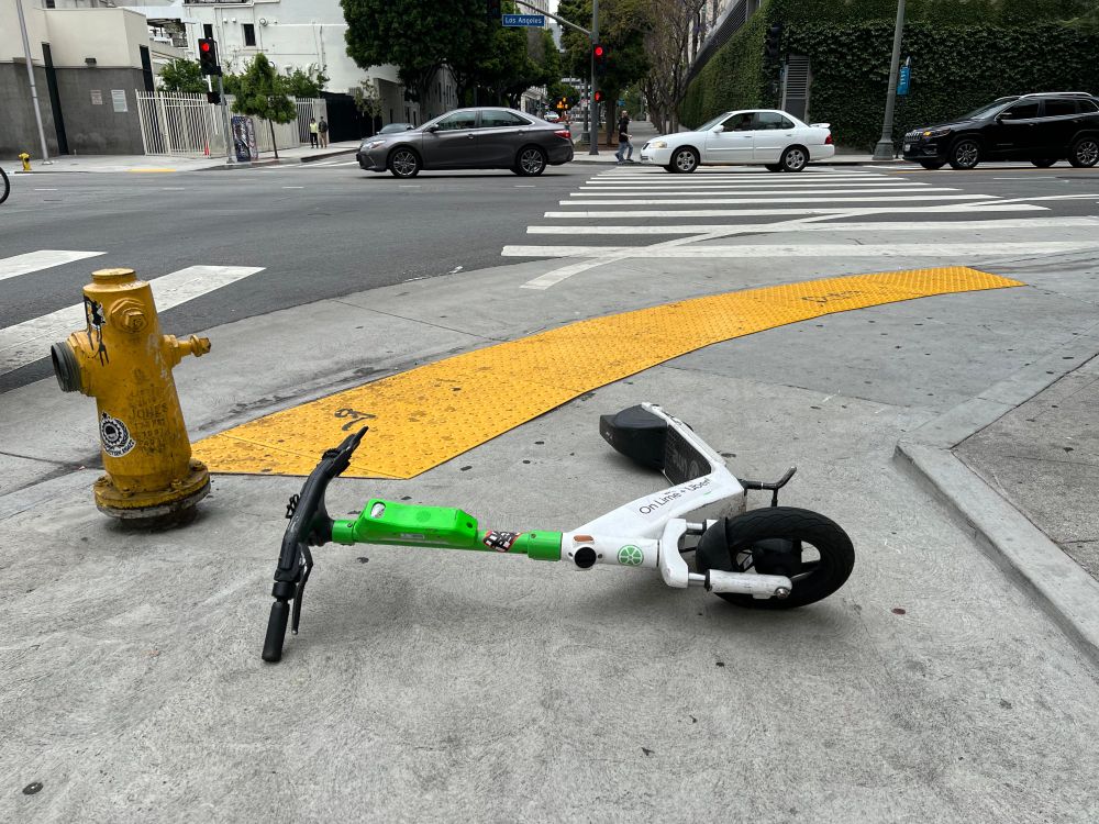electric scooter on "sharing" network blocking a sidewalk