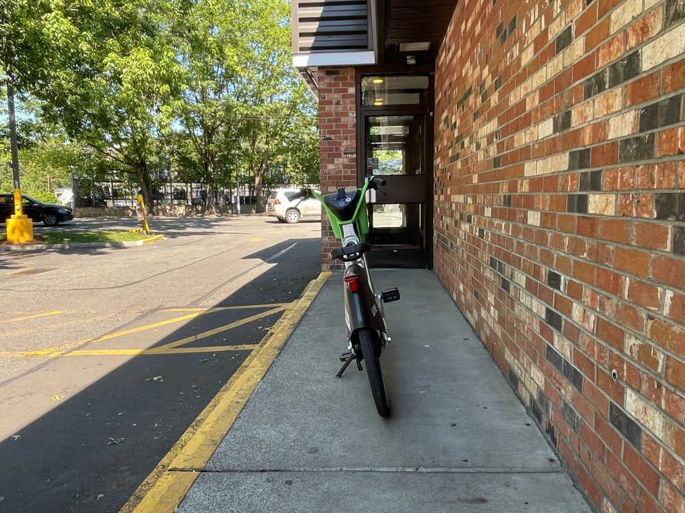 electric bike on "sharing" network blocking an accessible route to the entrance to a business