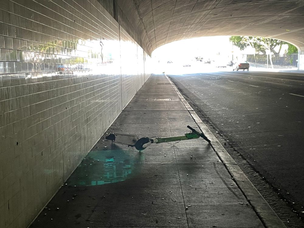 electric scooter on "sharing" network blocking a sidewalk