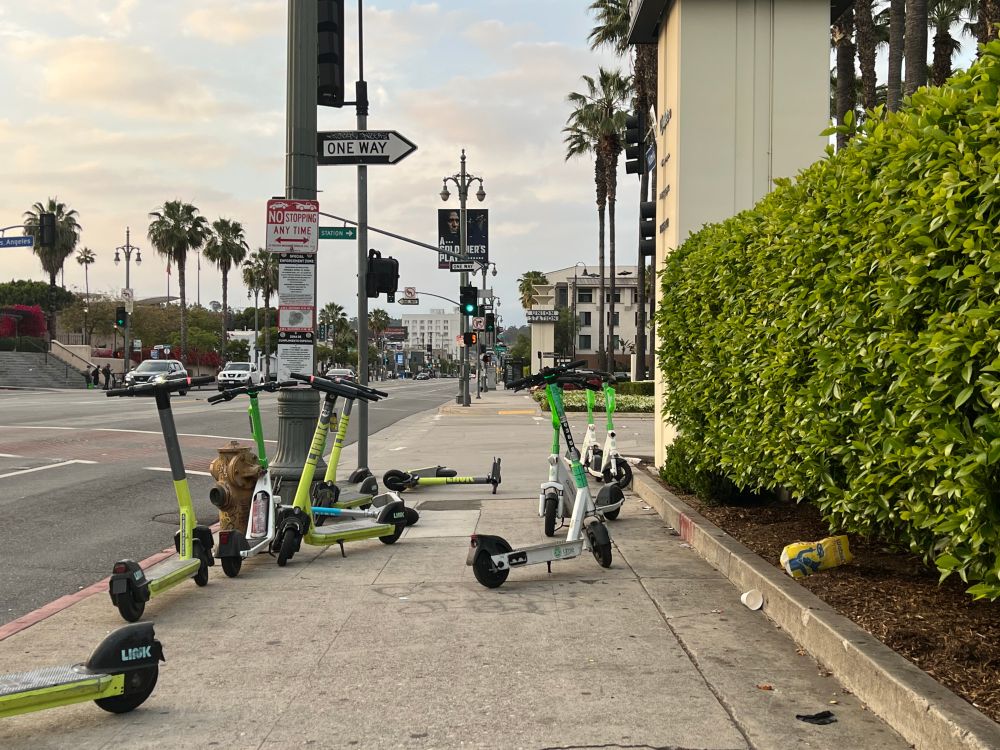 electric scooters on "sharing" network blocking a sidewalk