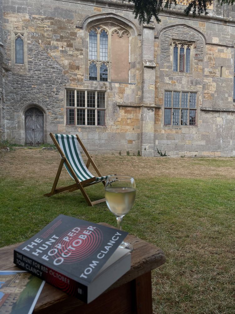 A book and a glass of wine outside an old building