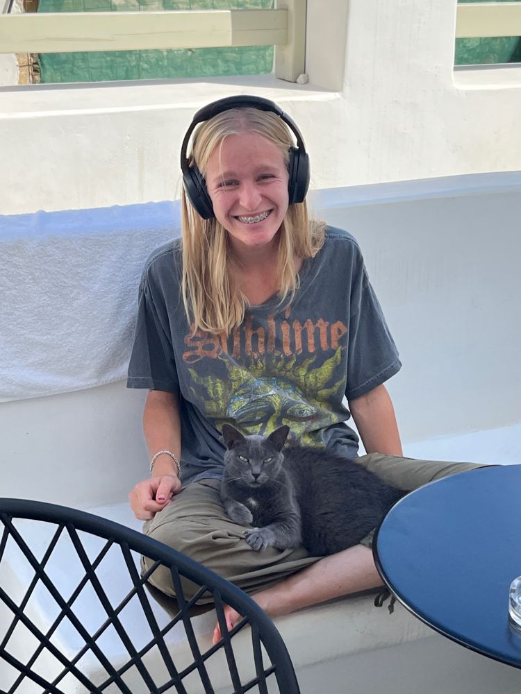 Third author, Rory Mendelow, petting a particularly affectionate feral cat despite my many warnings about fleas (Naxos, 2025). 