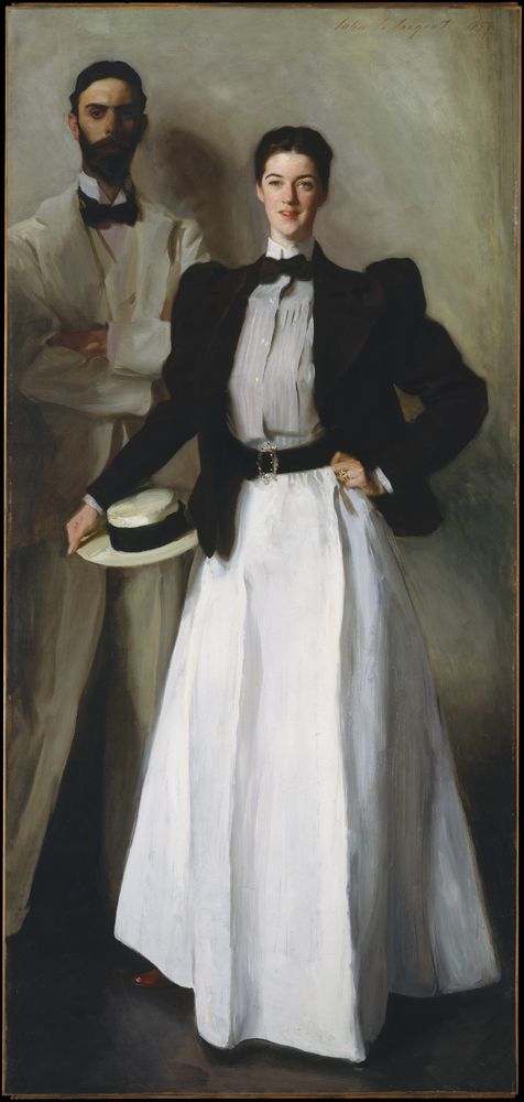 This painting, by John SInger Sargent, features a woman in what was considered a masculine outfit of dark short jacket, gray blouse with high collar and black bowtie, black belt, and white skirt. Her proper right arm holds a boater hat at her proper right hip; her proper left arm is bent with her hand on her hip She stands forthright in the foreground of this painting. Her husband, at the back left and in shadow, is dressed in white, his arms crossed in front of him. 