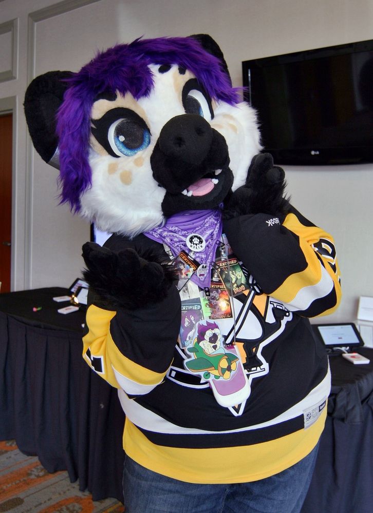 A spotted hyena poses for a photo, showing off her adorable smile.