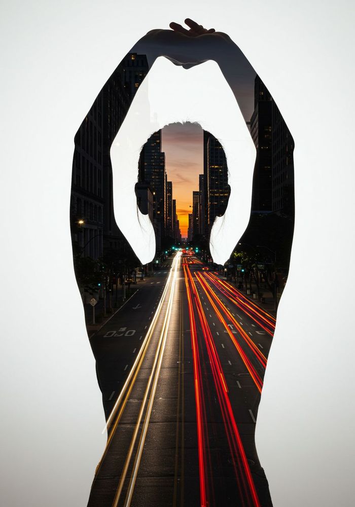 A double exposure concept. The primary image is a silhouette of a woman's head and shoulders as she stretches in the morning. Overlaid within her silhouette is a long-exposure shot of a bustling city street at dawn, with car light trails streaking through the dark. Her awakening mind is literally filled with the energy and possibilities of the city coming to life.
Style: Photographic Double Exposure, combining portraiture with long-exposure city photography. The effect is modern, abstract, and conceptual.
Composition: A clean, graphic silhouette of the woman against a plain, light-colored background. The city scene within is dynamic and full of motion, creating a stark contrast with the still silhouette.
Lighting: The silhouette is backlit to create a crisp edge. The internal city scene has the characteristic lighting of a dawn cityscape: dark buildings, bright streetlights, and colorful streaks of light from traffic.
Adjectives: Conceptual, Dynamic, Modern,