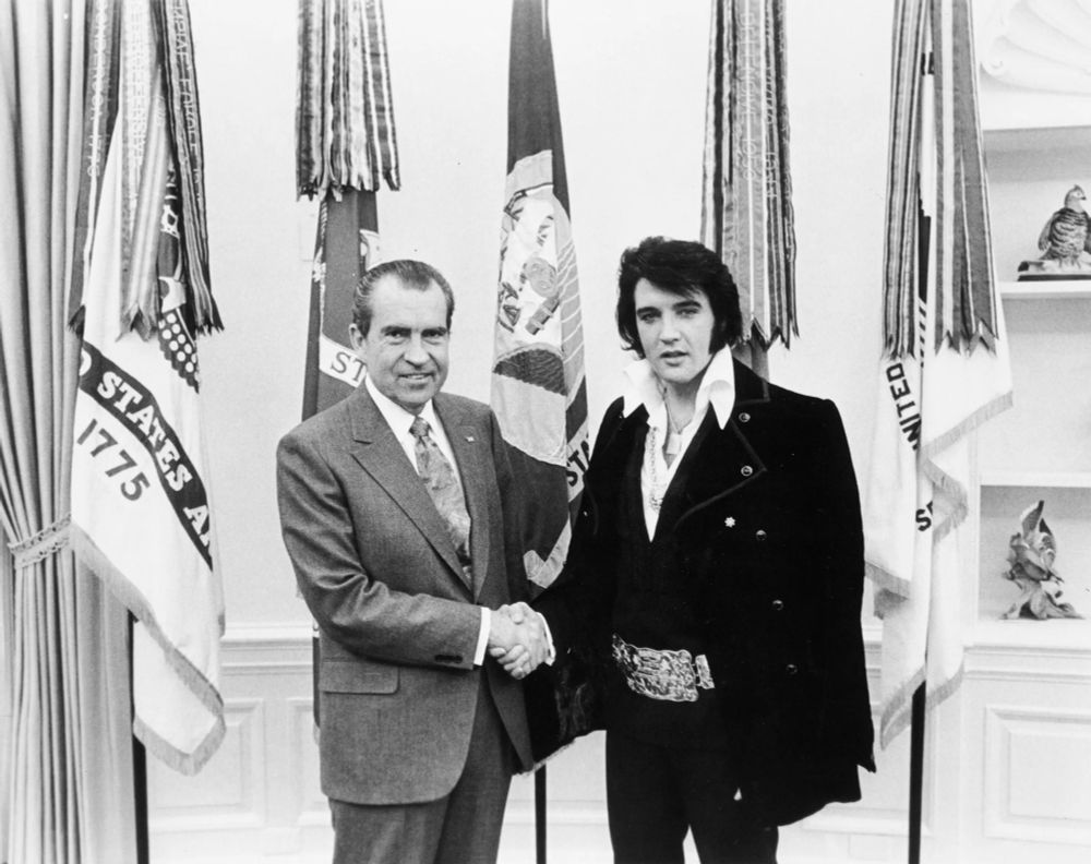A black and white photo of Nixon and Elvis shaking hands
