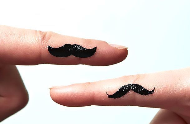 two fingers with mustache tattoos 