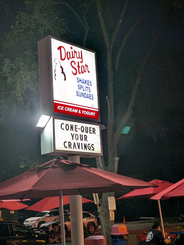 Sign of Dairy Star lot up at night 