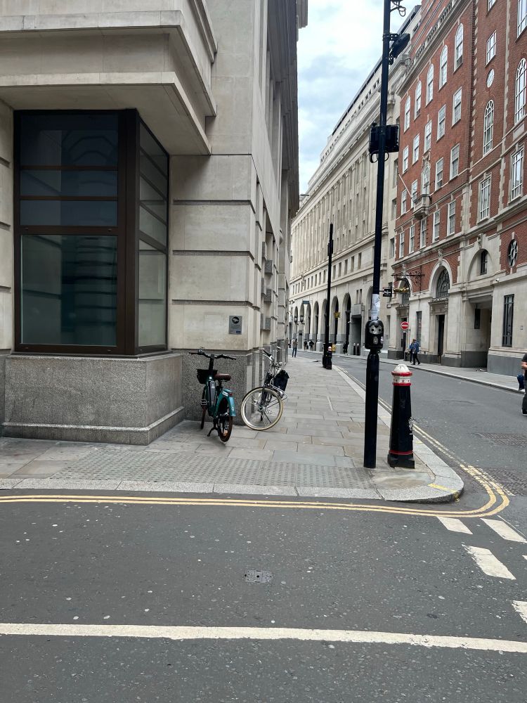 On the far side of the junction, a new dropped kerb has been installed with grey tactile paving