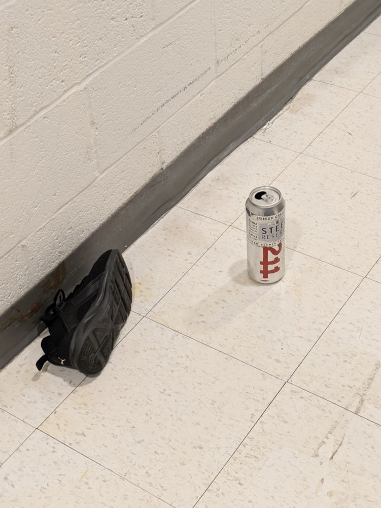 a closeup of the aforementioned shoe and beer can