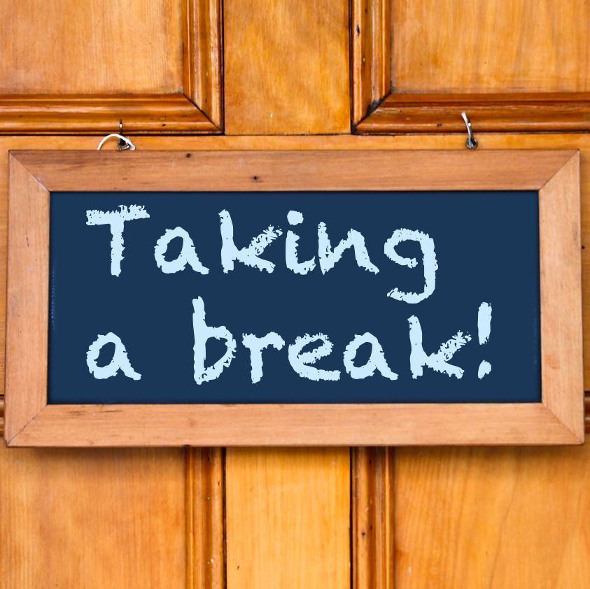 Chalkboard sign on a door with text "Taking a break!"