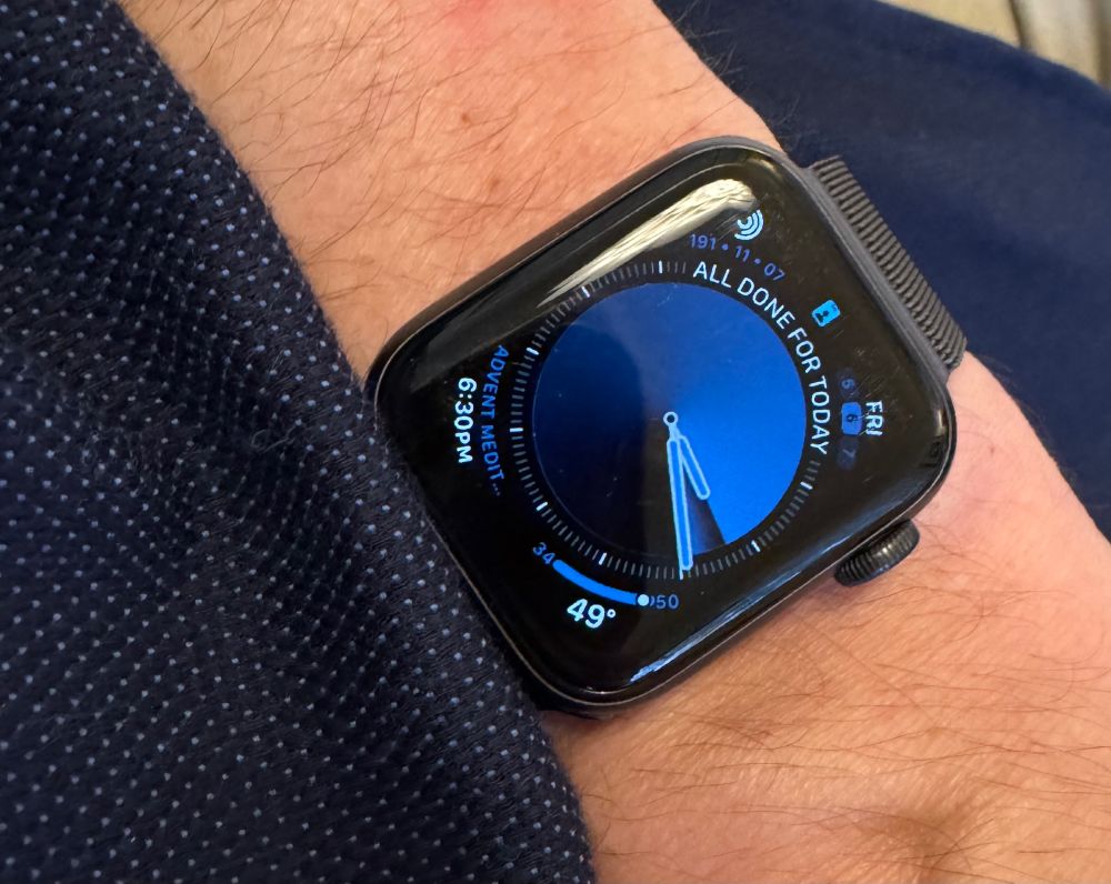 A photo of my Apple Watch on my wrist, with a blue gradient face, next to my similarly blue shirt.