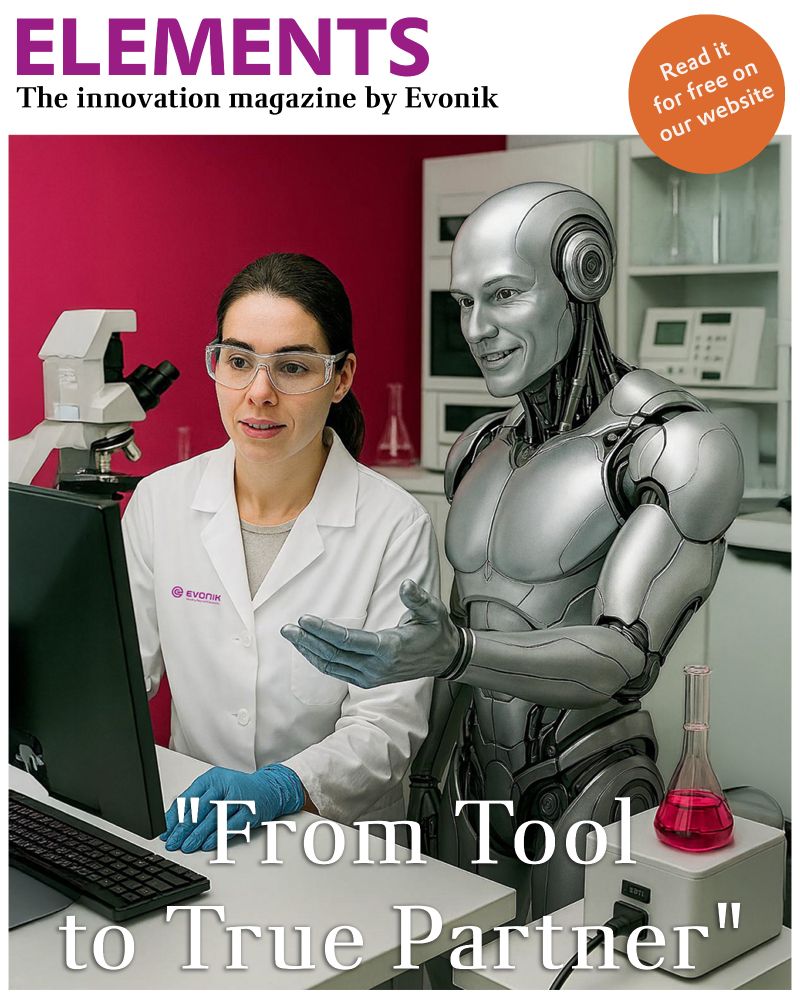 A scientist in a lab coat with the Evonik logo stands at a desk in a laboratory, looking at a computer screen. Beside her stands a humanoid robot, appearing to assist her. A microscope and a flask with pink liquid are on the desk. In the background, shelves with lab equipment are visible. The title "ELEMENTS – The innovation magazine by Evonik" is displayed at the top, with an orange circle stating, "Read it for free on our website." At the bottom, the text reads, "From Tool to True Partner.