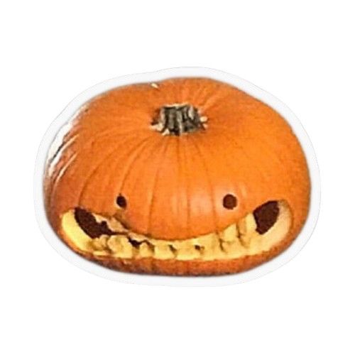 A carved pumpkin with a gigantic and slightly awkward smile