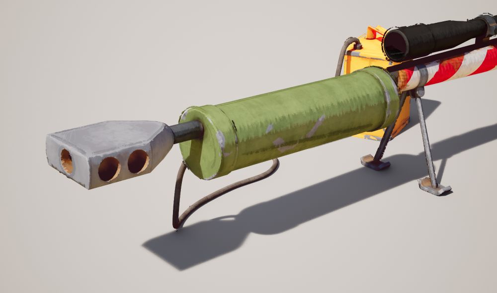 A closeup of the muzzle brake and water cooler