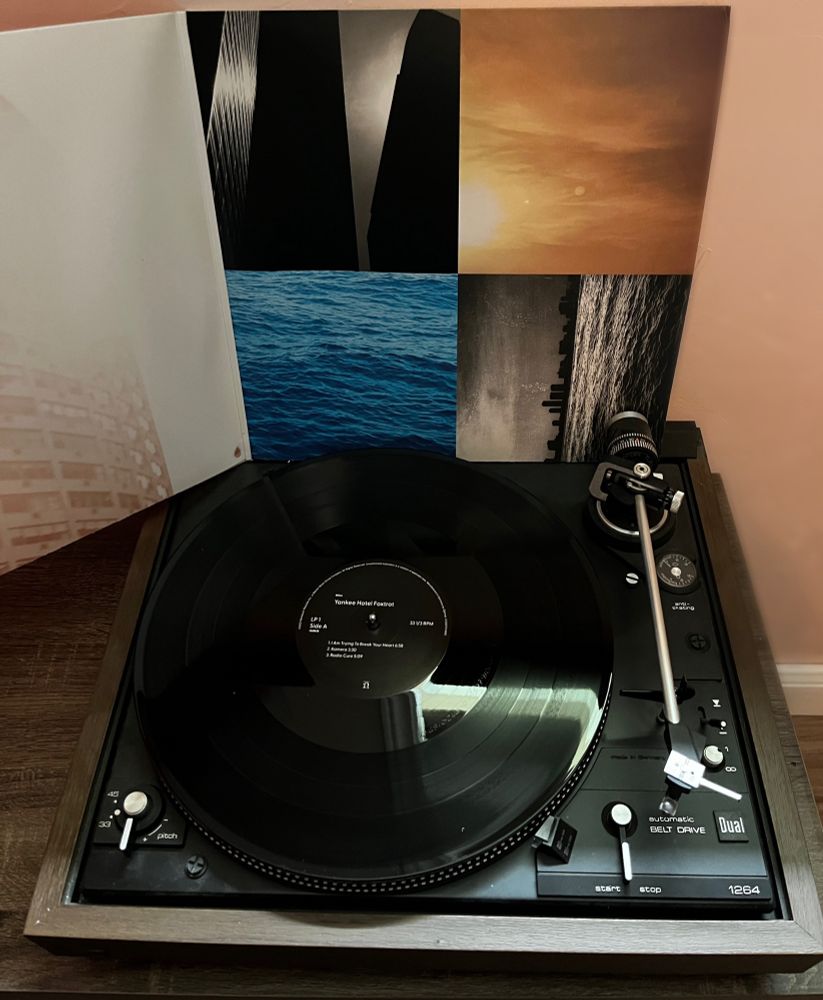 Vinyl on my record player with the album artwork in the background - Wilco Yankee Hotel Foxtrot.