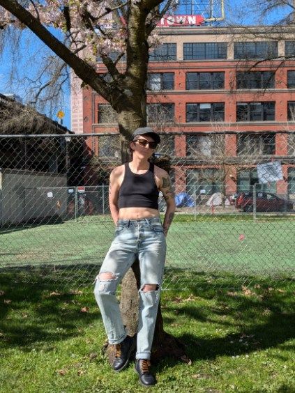 Posing against a tree in a campaign to Levi's nonbinary modeling