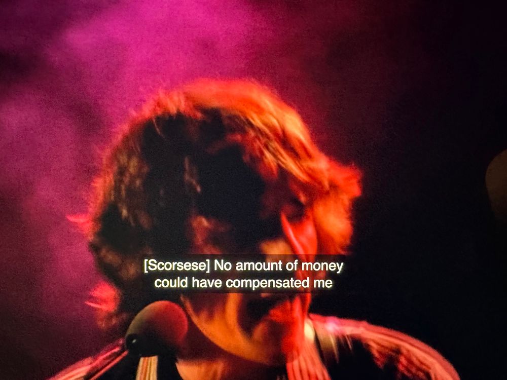 Frame from Mr. Scorsese with Danko singing. Caption: [Scorsese] No amount of money could have compensated me