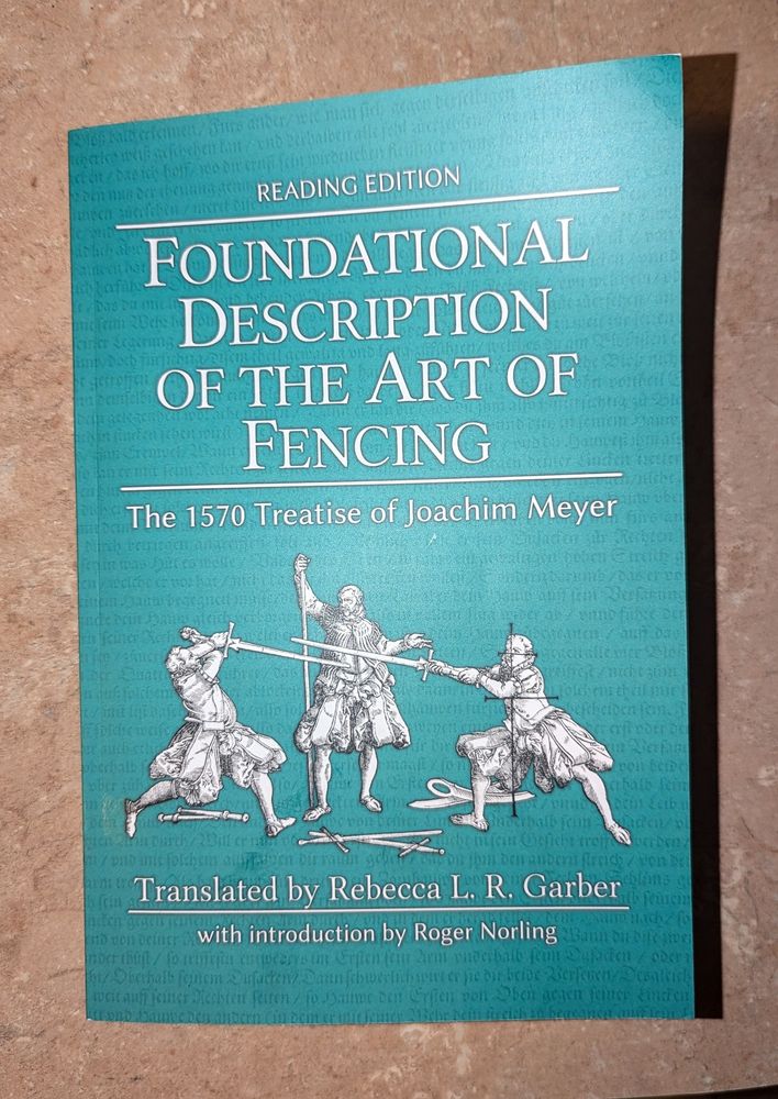 A photograph of a book, 'Foundational Description of the Art of Fencing: The 1570 Treatise of Joachim Meyer" translated by Rebecca L. R. Garber with introduction by Roger Norling. 