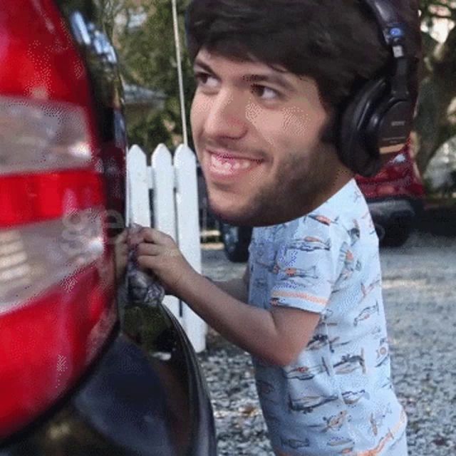 a man wearing headphones and a shirt with planes on it