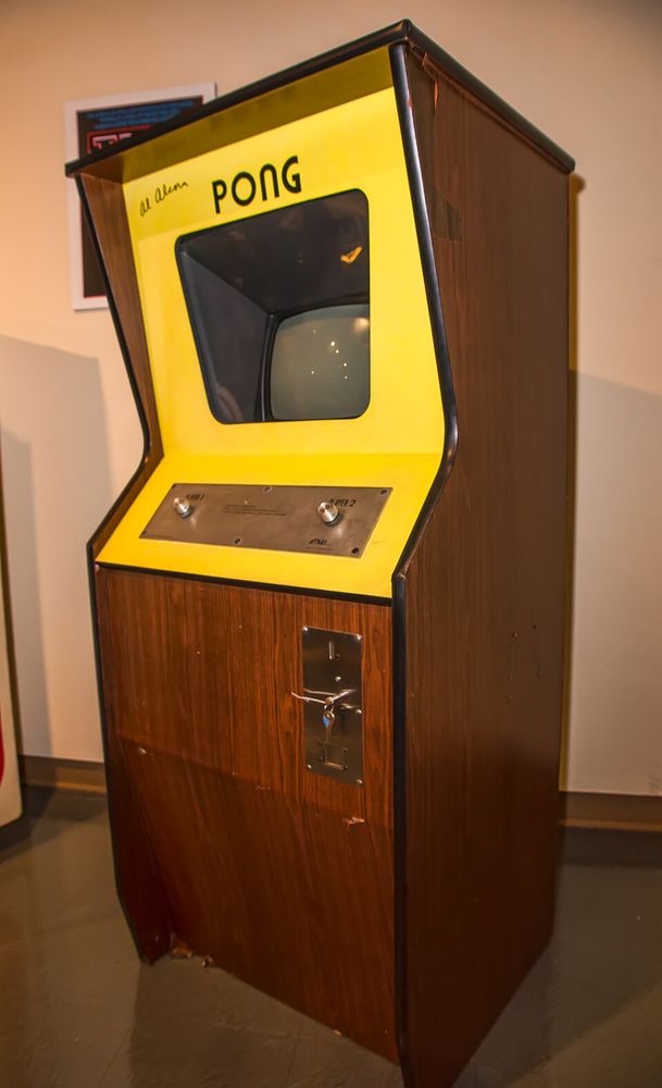 Full size Pong cabinet all varnished wood with a yellow surround around the screen and controls