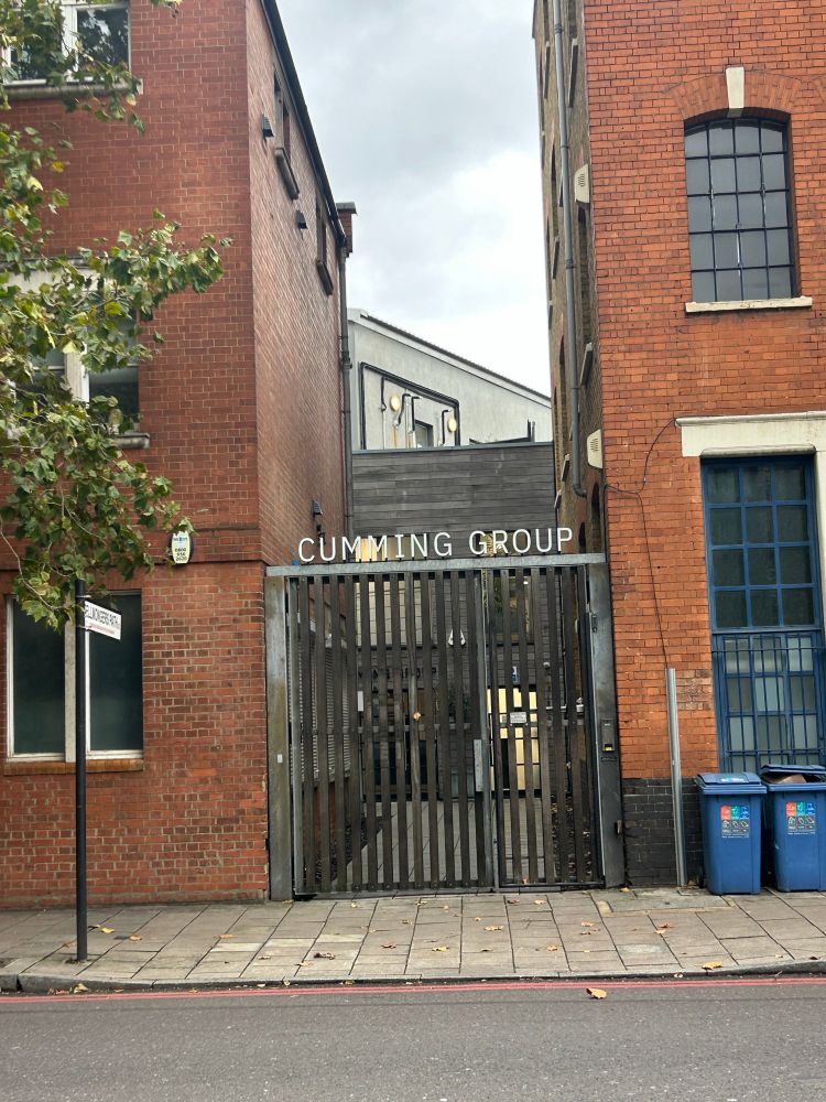 Gate in Southwark London titled “Cumming Group”