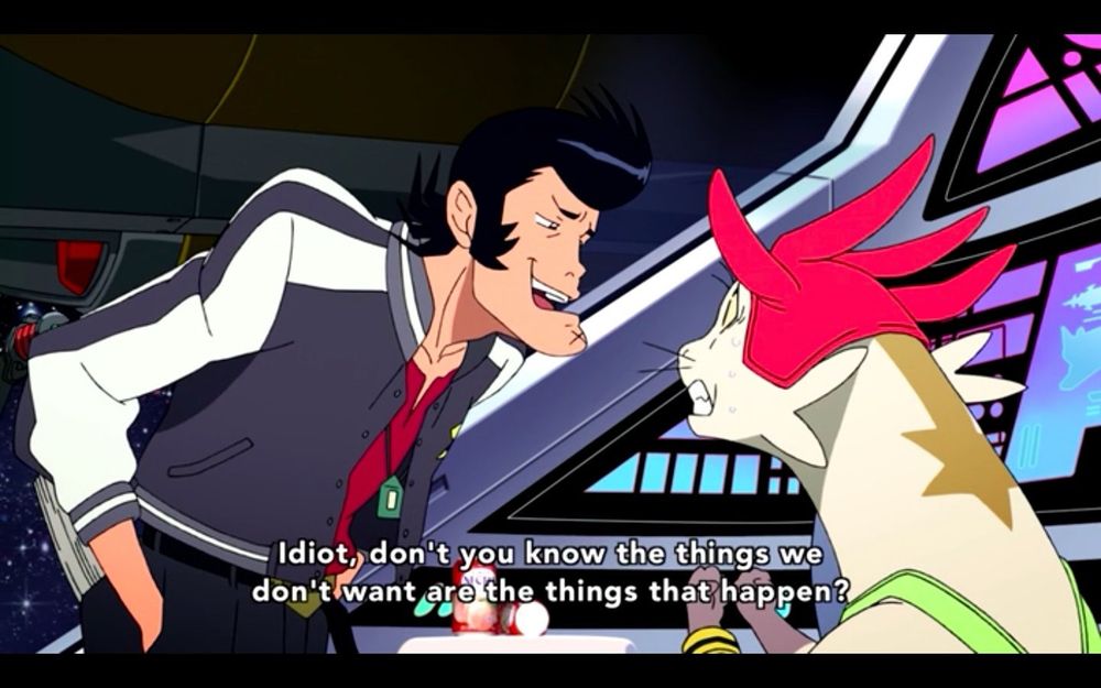 Screenshot from the anime ‘Space Dandy.’ Dandy, a rockabilly-type man with a square jaw and a formidable pompadour, who wears a blue and white letterman jacket, speaks condescendingly to his crewmate Meow, a bipedal cat-otter alien wearing a red hat with many points and a lime green tanktop. Dandy’s jaw is thrust out in a fairly goofy way and Meow’s fists are clenched and his teeth are gritted in frustration. They are on the bridge of a starship. Subtitle text on the bottom of the screen reads:
SPACE DANDY: “Idiot, don’t you know the things we don’t want to happen are the things that happen?”