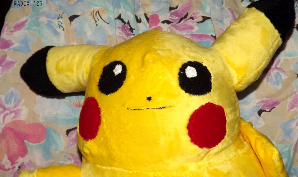 Photo of a hand-made Pikachu plush, close-up.