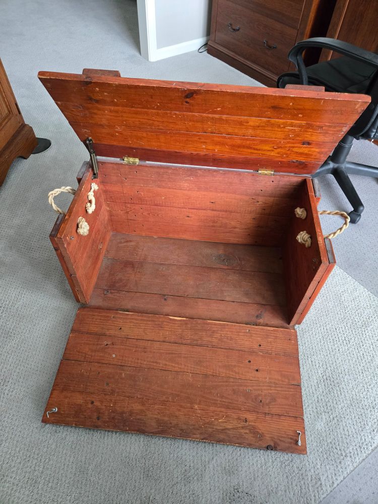 The opened toy chest. The top opens as well as the front