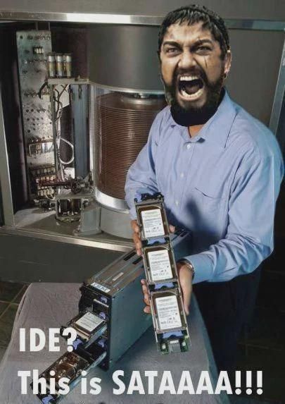 A man intensely displaying a SATA drive for your viewing pleasure. His face has been replaced with the main character of 300 (a spartan), and he shouts IDE? This is SATAAAAAA!!