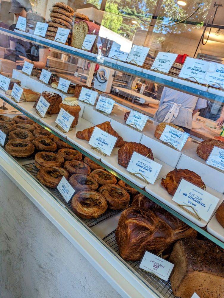 Their display with pastries, with croissants, and quiches made with croissant pastry, and doughnuts, and cookies and more