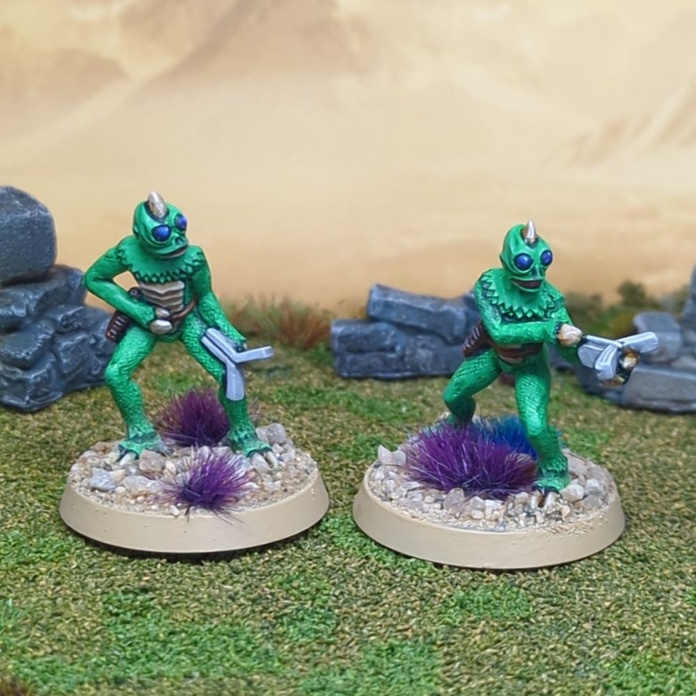 2 green lizard humanoid folks inspired by classic scifi 