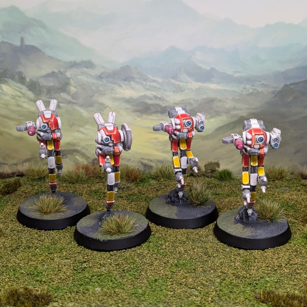 4 miniature drone figures. Small robots with 3 hanging arms below a main "head". Painted in orange, white and yellow. 