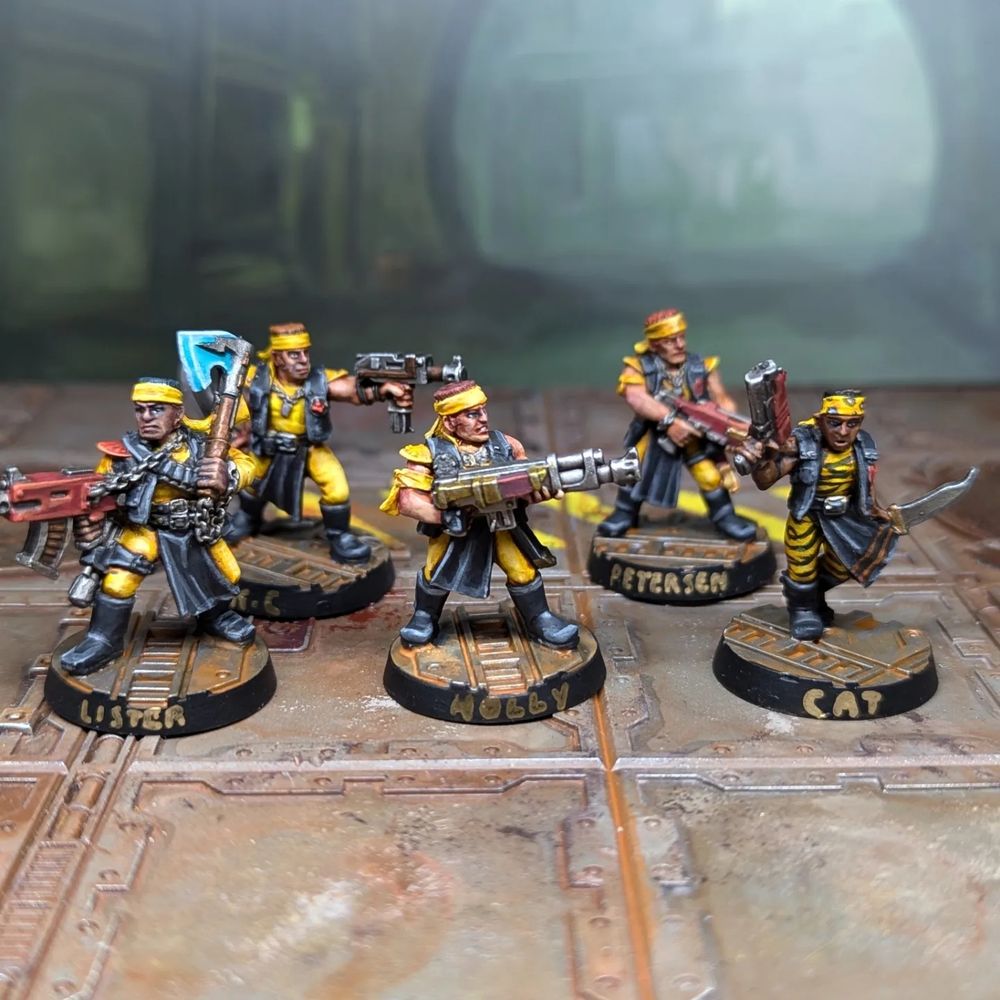 5 classic Necromunda Orlock gangers in yellow and black outfits with an array of weaponry. 