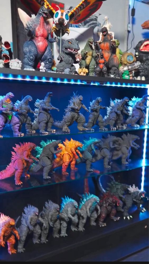 Godzilla figure collection in a display case