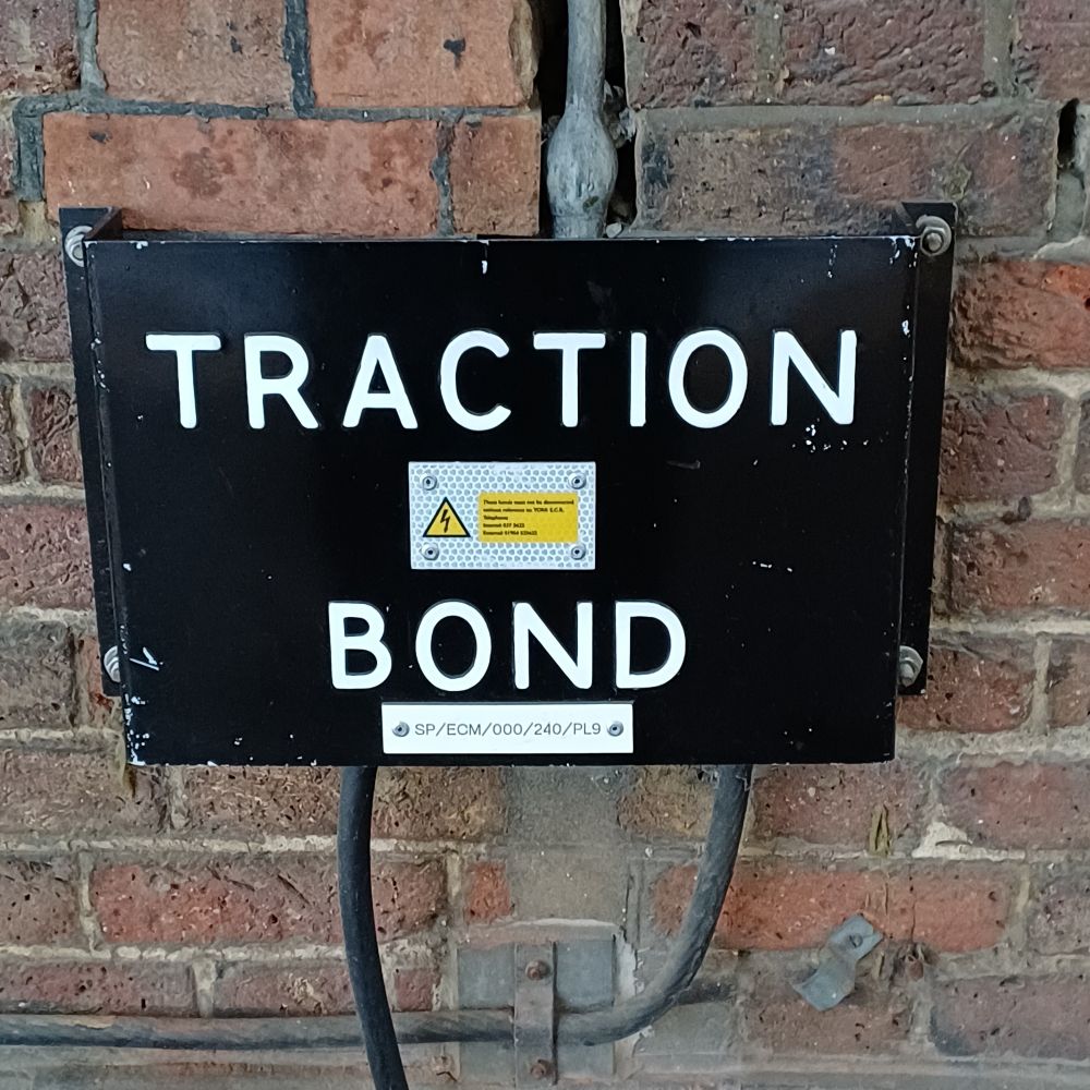 Railway sign saying "Traction Bond". Who knows what it means. I feel it would ruin it to find out. 
