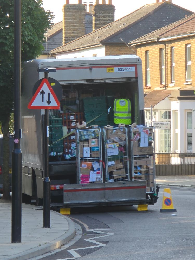 A Tesco Lorry parked on a corner, on a single yellow and in a cycle lane