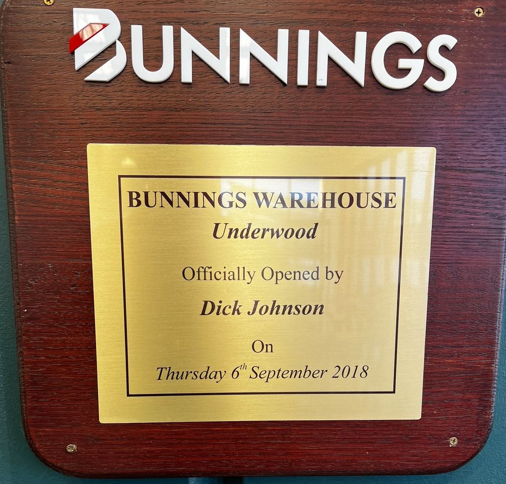 A picture of a commemorative plaque stating that Dick Johnson (a retired Australian racing car driver) opened a hardware store in September 2018. 