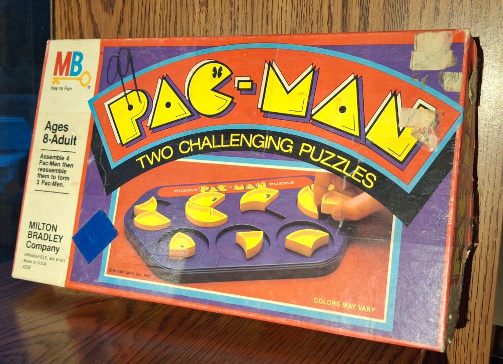 The front box of "Pac-Man: Two Challenging Puzzles" with YELLOW prices on a BLUE base. But it does say, "Colors may vary."