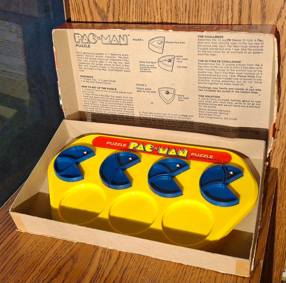 Inside the box, with the instructions printed inside the lid, are BLUE pieces on a YELLOW background.