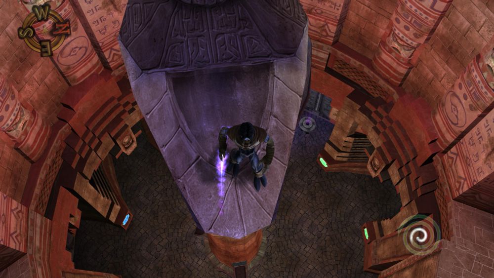 raziel standing at the edge of a tall pillar overlooking a large red stone room below