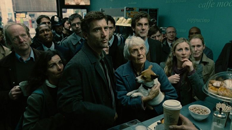 Opening shot from children of men of people standing around a coffee shop