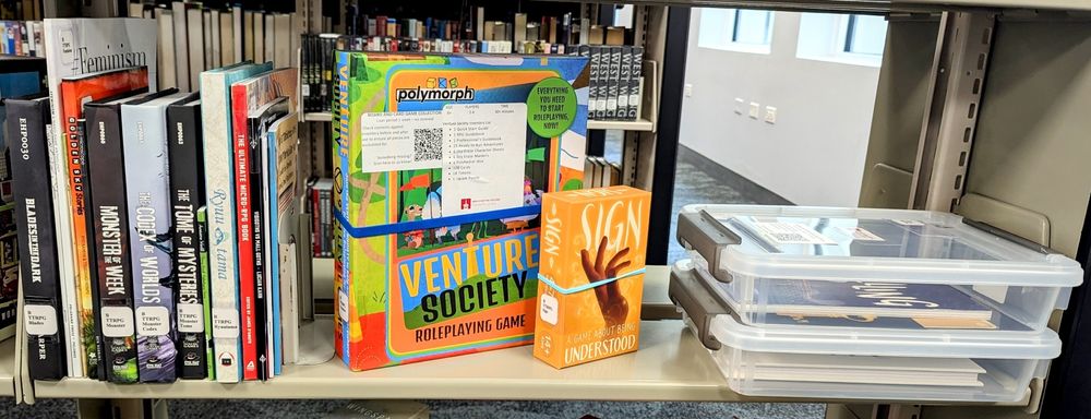 TTRPGs on a shelf at an academic library
