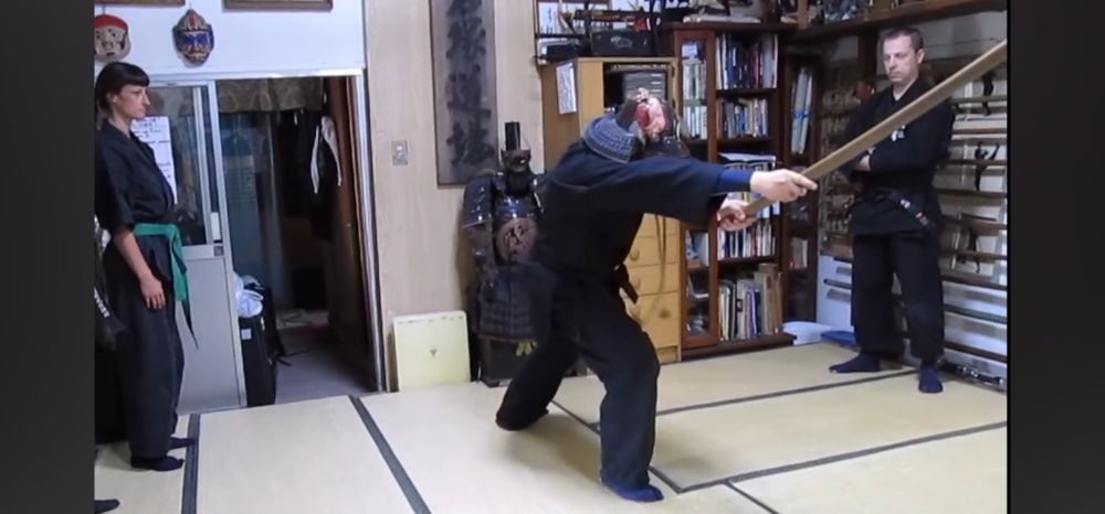 Kacem Zoughari of the Bujinkan Dojo, wearing a black dogi (martial arts uniform), a samurai kabuto (helmet), demonstrating how a proper tsuki (thrust) with a katana protects vital areas of the body. This translates to other buki (weapons) as well as unarmed Taijutsu
