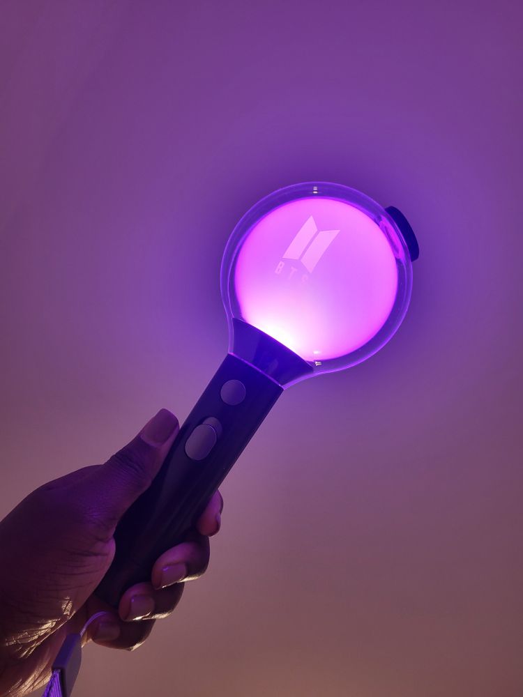a glowing purple ARMY lightstick