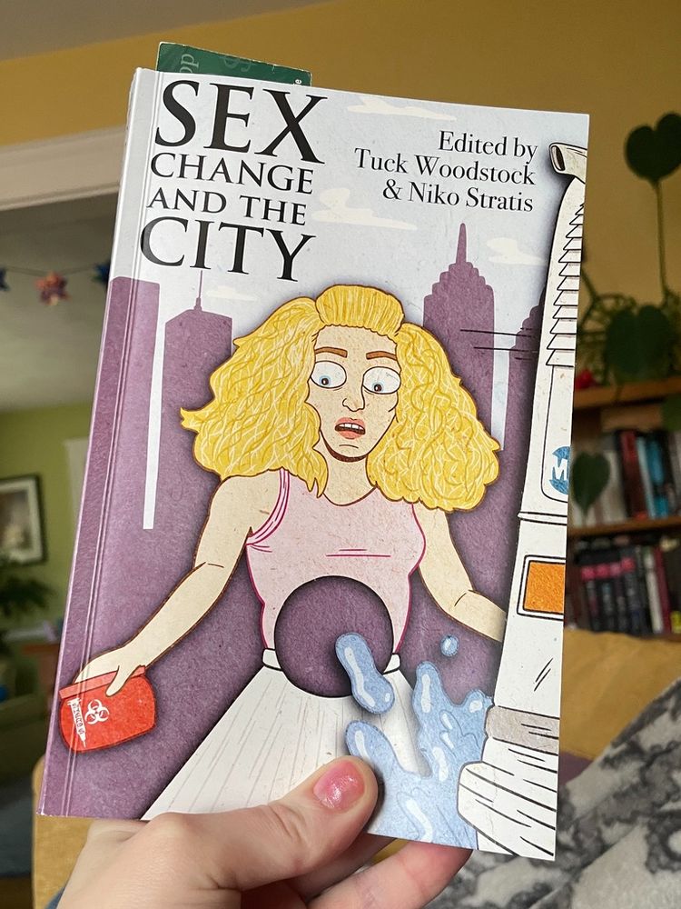 The book "Sex Change and the City" edited by Tuck Woodstock and Niko Straits. Featuring an illustration of Carrie Bradshaw holding a sharps container purse and with a hole cut in her abdomen.
