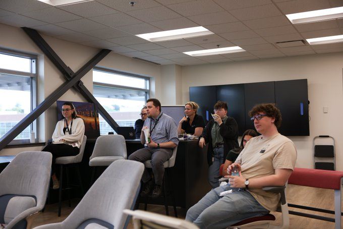 A group of NCITE staff and students sits and listens to Professor Ghazi-Tehrani speak. 