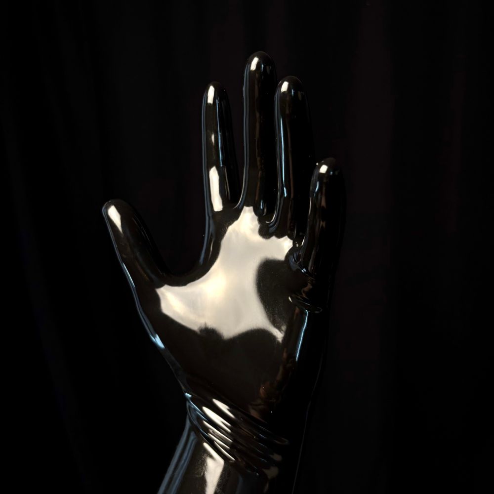 Black latex gloves on a black background