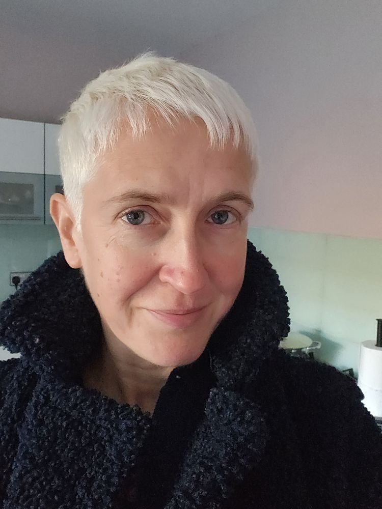 Me in a navy coat with 100% bleached hair 